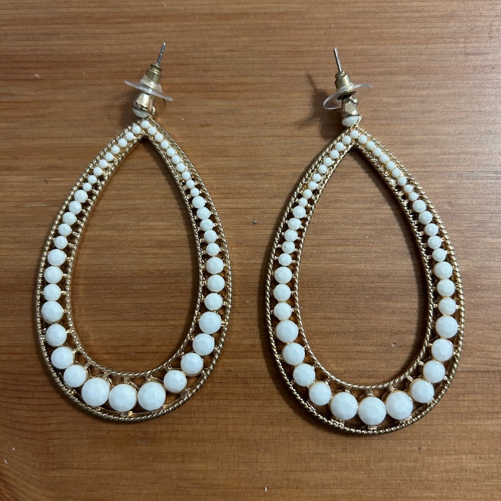 Gold hoops with faux white stone accents. Earring pair